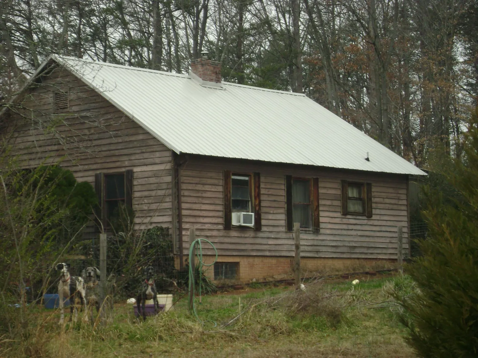 White metal roof on an old wood sided farmhouse, from a Metal Roof Installation job in Norfolk